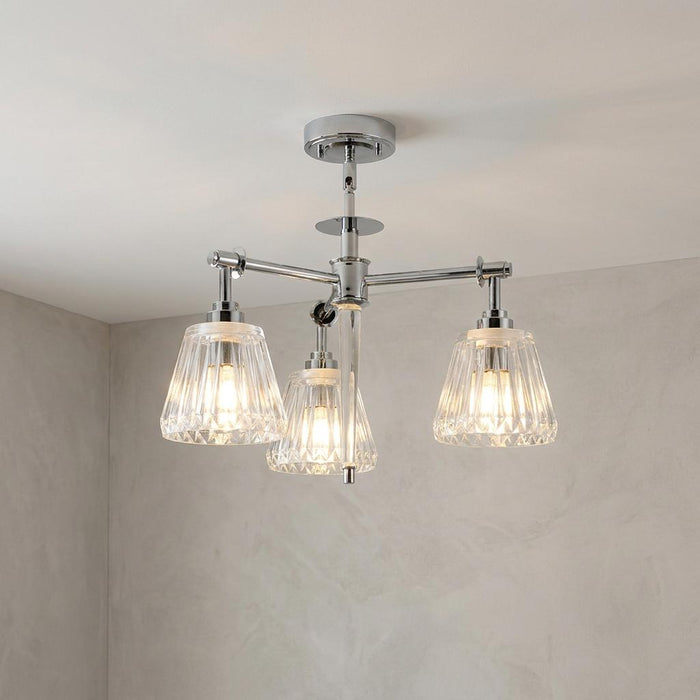 Agatha three-light pendant in polished chrome with ribbed glass shades mounted on a neutral ceiling.