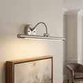 Brushed nickel Alton 1 Light LED picture light illuminating an abstract painting in a modern interior setting.