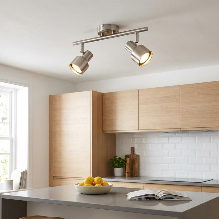 Amalfi 2 light brushed nickel spotlight fixture mounted on a white kitchen ceiling above a modern island.
