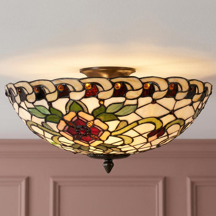 Large semi-flush Tiffany ceiling light with a vibrant floral stained glass shade and bronze finish.