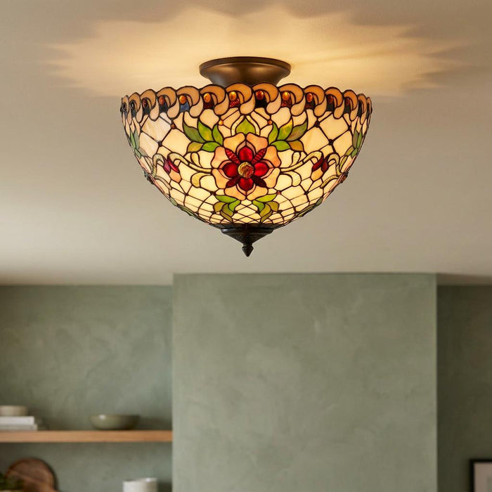 Illuminated Tiffany-style semi-flush ceiling light featuring a red floral stained glass pattern.