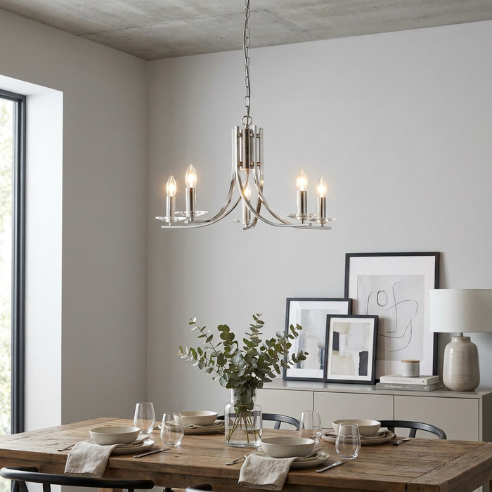 Satin silver 5-light chandelier with glass sconces hanging above a rustic wooden dining table in a modern home.