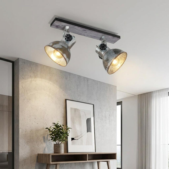 Industrial-style distressed steel spotlights on a wooden bar mounted to a ceiling in a modern room.