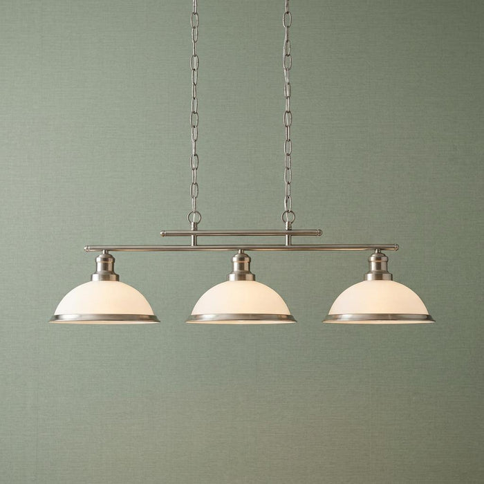 Bistro Satin Silver 3 Light Kitchen Ceiling Light with white dome shades against a green textured wall.