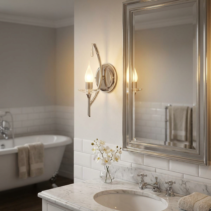 Brightwell polished chrome bathroom wall light with a candle bulb mounted beside a silver-framed mirror.
