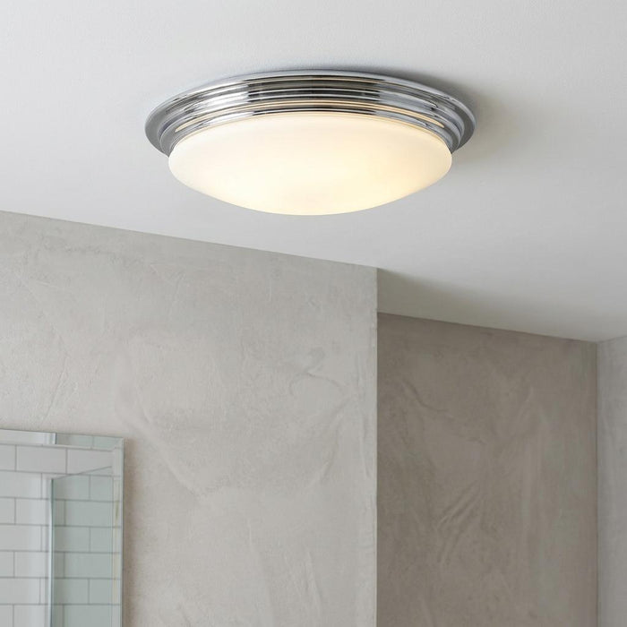 Brompton polished chrome flush LED ceiling light with an opal glass shade mounted on a white bathroom ceiling.