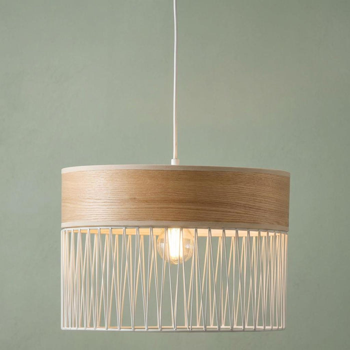 Burbank ceiling pendant light with wood effect top and white wire frame shade against a green wall.