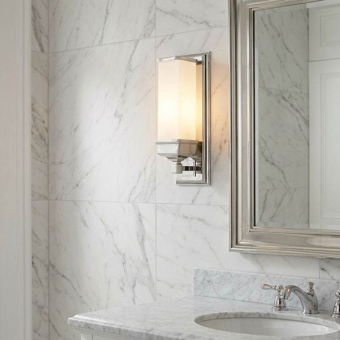 Cambridge polished chrome bathroom wall light with a frosted glass shade, mounted on a white marble wall.