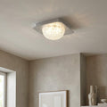 Square silver LED ceiling flush light with a textured acrylic dome diffuser casting a warm glow.