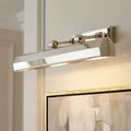 Polished nickel picture light with an adjustable rectangular shade mounted above a framed abstract painting.