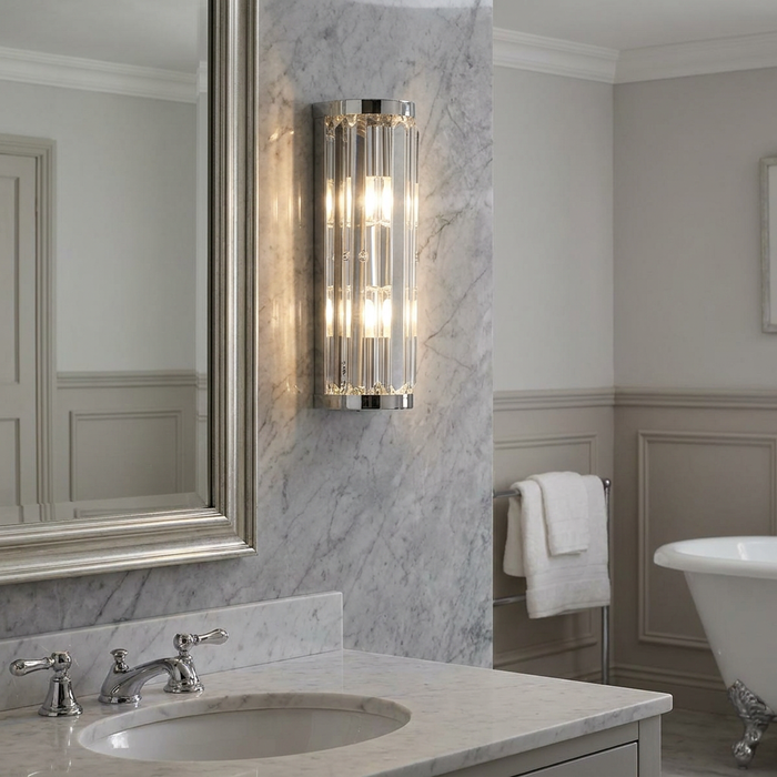 Crystal 2 Light IP44 Polished Chrome Bathroom Wall Light mounted on a marble wall next to a silver-framed mirror.