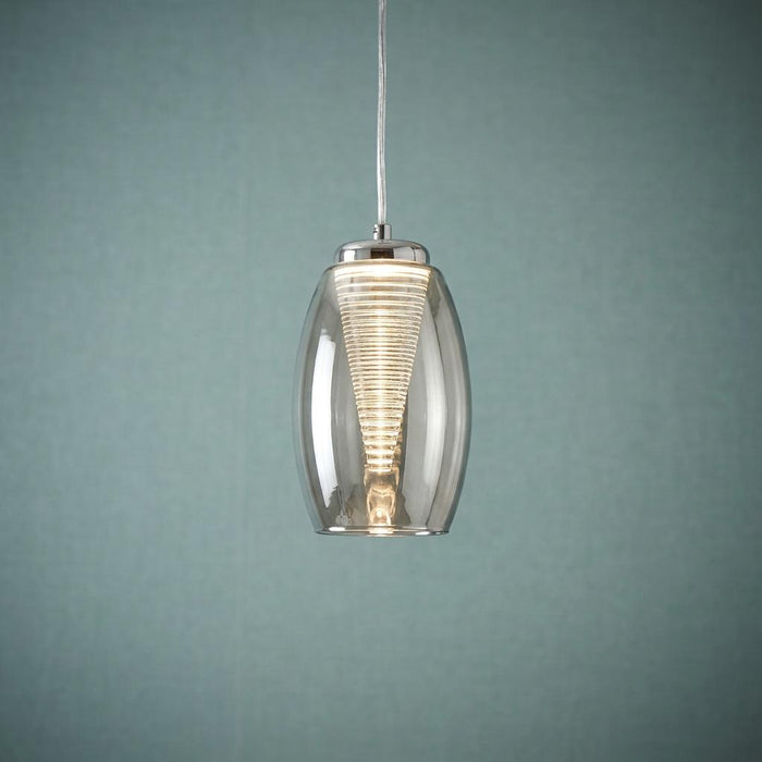 Cyclone 1 light ceiling pendant with a smoked glass shade and a glowing ribbed internal cone against a teal wall.