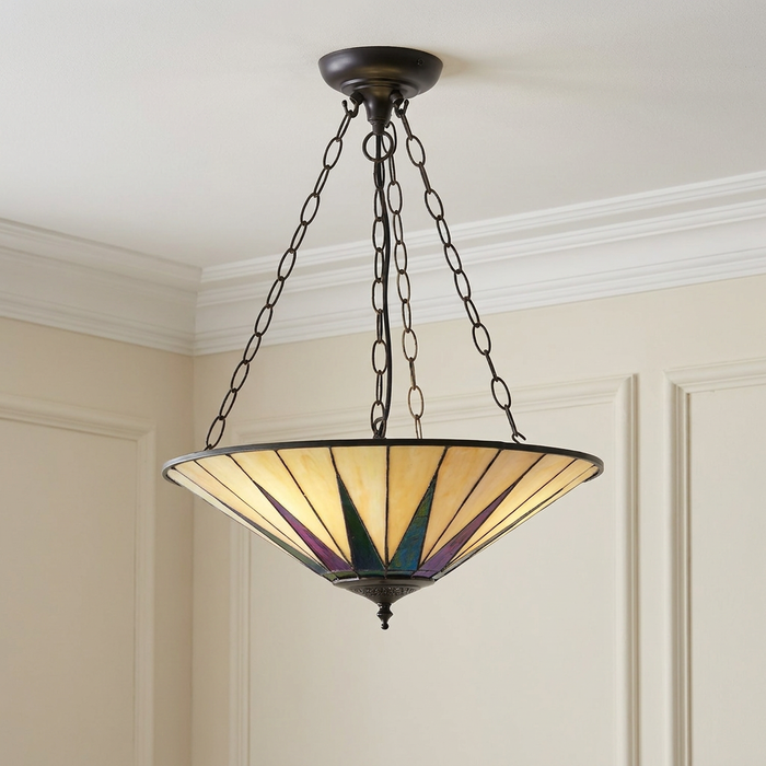 Inverted Tiffany ceiling light with a cream and iridescent star-patterned glass shade hanging by dark chains.