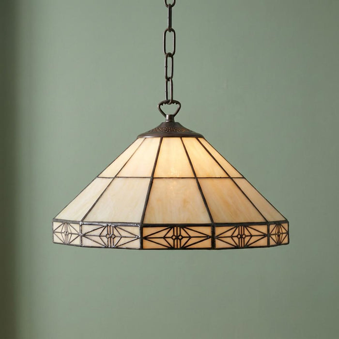 Dorchester Tiffany ceiling light with cream stained glass and geometric patterns suspended against a green wall.