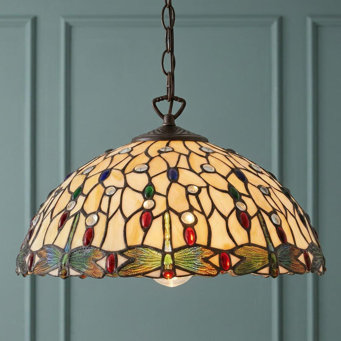 Dragonfly II Tiffany pendant lamp with cream stained glass and colorful jewels against a teal paneled wall.
