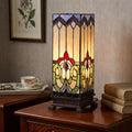 Rectangular Tiffany table lamp with floral stained glass patterns on a wooden bedside table.