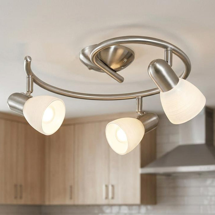 Eglo Dakar 1 three-light nickel spotlight with white glass shades installed on a kitchen ceiling.