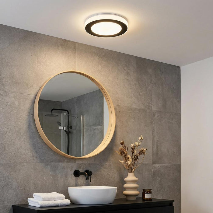 Modern Eglo LED Carpi flush light with a black ring on a white ceiling in a contemporary bathroom.