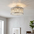 Elise 5 light chrome and crystal flush ceiling light illuminating a living room with decorative light patterns.
