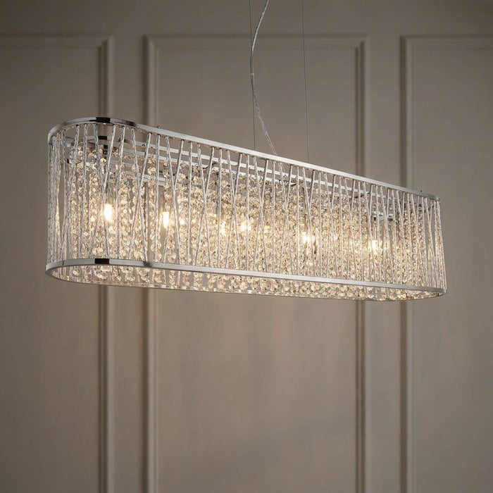 Elise 8 Light Chrome and Crystal oval pendant light with cascading crystal drops against a paneled wall.