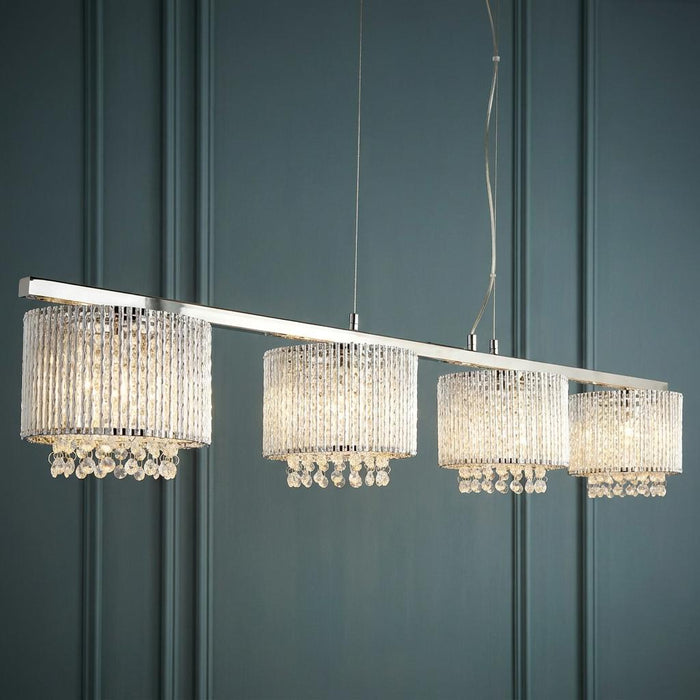 Elise 4-light chrome bar pendant with crystal cylinder shades and hanging drops against a teal paneled wall.