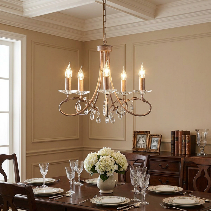 Elstead Christina 5-light silver and gold chandelier with crystal droplets hanging over a dining table.