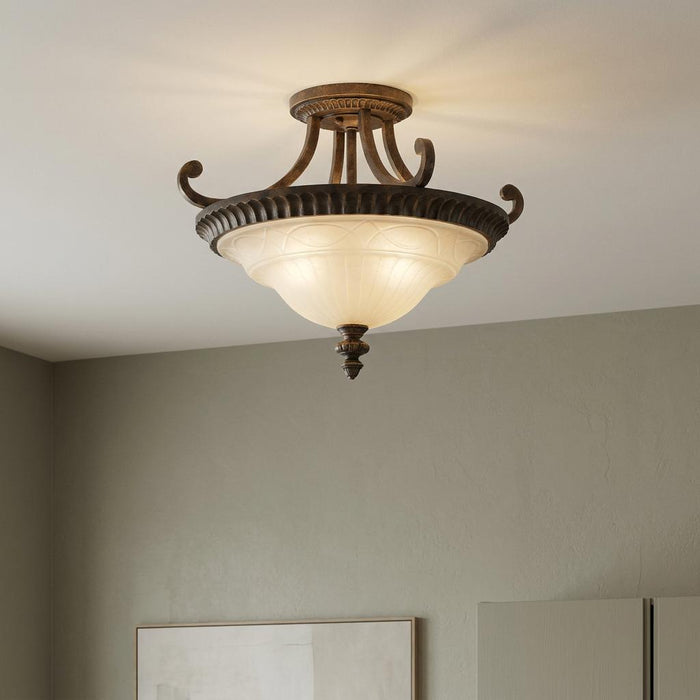 Ornate semi-flush ceiling light with walnut finish and frosted glass bowl mounted in a neutral room.