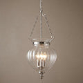 Three-light polished nickel ceiling lantern with clear ribbed glass globe hanging against a neutral wall.