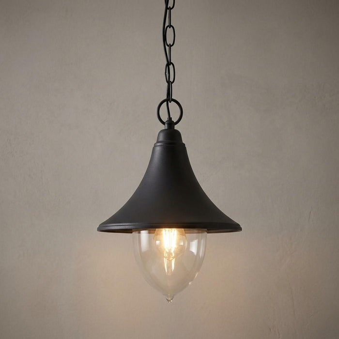 Elstead Firenze black outdoor pendant light with a clear glass shade and hanging chain against a textured wall.