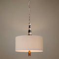 Pendant ceiling light with a cream fabric drum shade, a black and silver striped cone top, and a gold leaf finial.