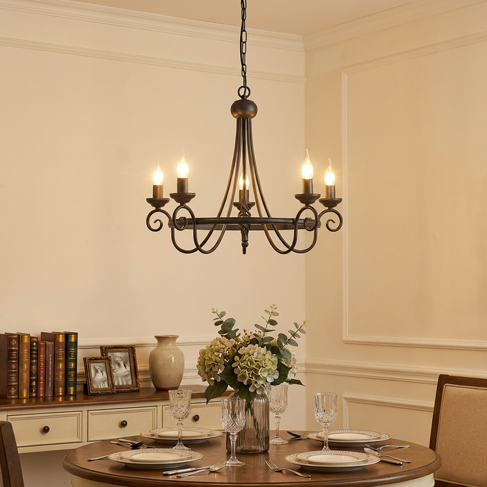 Elstead Harlech black 5-light chandelier hanging above a set dining table in a warm, traditional interior.
