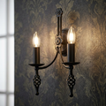 Elstead Lighting Belfry 2-light black wall sconce with ornate forged details on dark damask wallpaper.