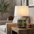 Elstead Lighting Columbus Table Lamp with a dark textured glass base and white shade on a rustic wooden side table.