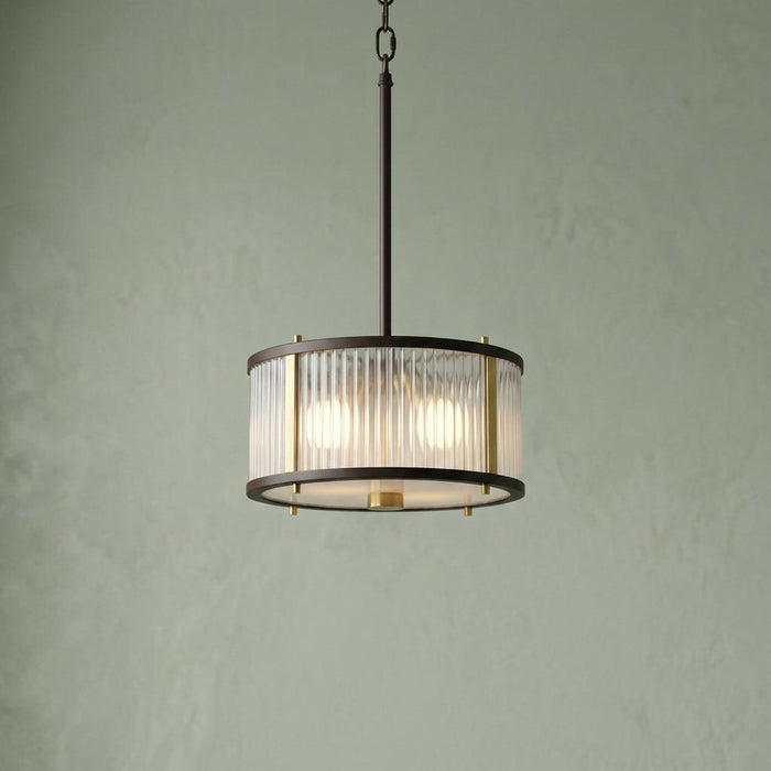 Elstead Lighting Corona 2-light bronze ceiling pendant with ribbed glass and brass accents against a green wall.