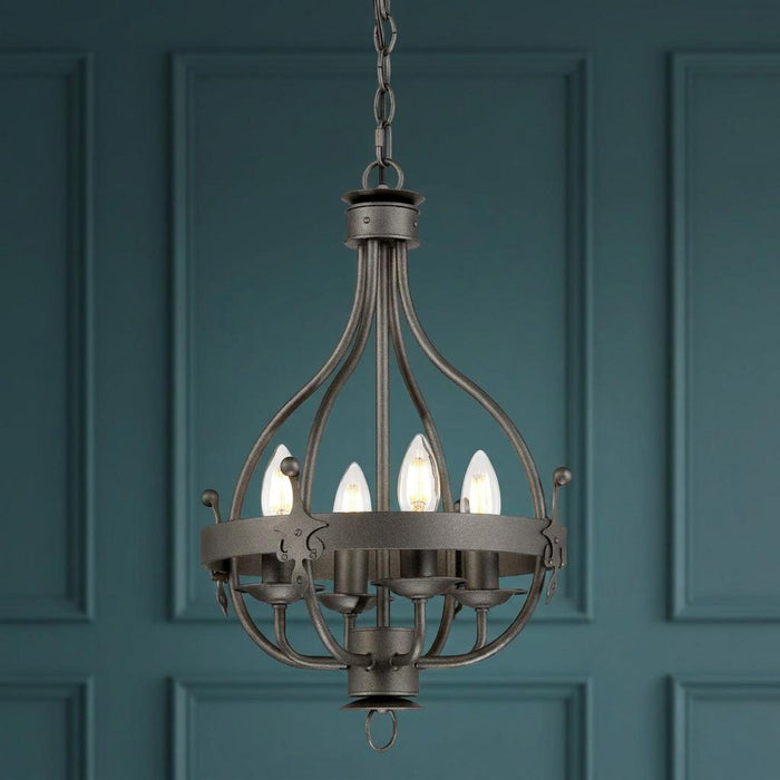 Traditional graphite 4-light pendant with candle bulbs hanging against a dark teal paneled wall.
