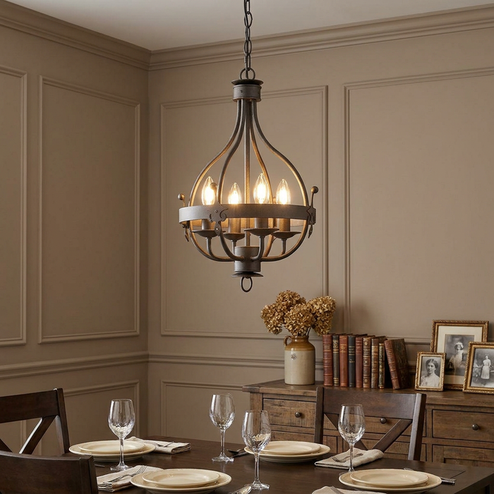 A graphite four-light pendant with a medieval-inspired cage frame hangs over a wooden dining table.