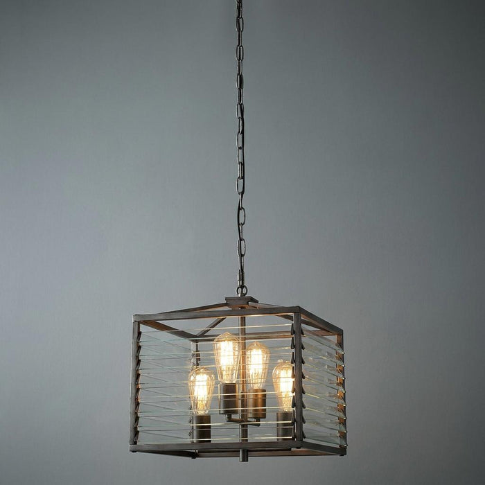 Gunmetal pendant light with a square frame and glass louvre slats, housing four bulbs against a grey background.