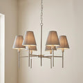 Elstead Lucerne 6-light brushed nickel chandelier with grey fabric tapered shades against a plain neutral wall.