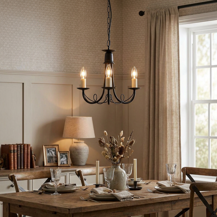 Elstead Minster black 3-light chandelier hanging over a rustic dining table with neutral decor.