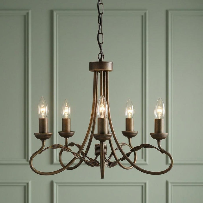 Elstead Olivia 5-light chandelier with bronze-finished scrollwork and leaf details against a green paneled wall.
