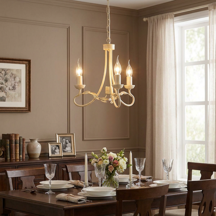 Ivory and gold Elstead Olivia chandelier with three candle-style lights above a set dining room table.