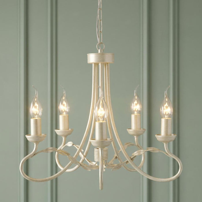 Elstead Olivia Ivory and Gold 5-light chandelier with leaf detailing against a green paneled wall.