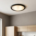 Elstead Pembroke flush ceiling light with black and gold twisted frame and frosted glass in a modern kitchen.