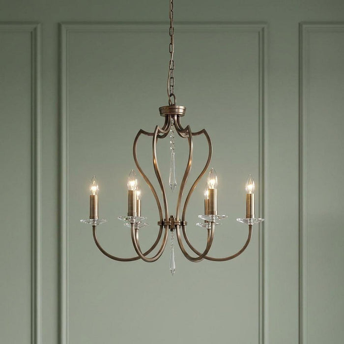 Elstead Pimlico 6-light dark bronze chandelier with elegant curved arms and crystal accents against a green wall.