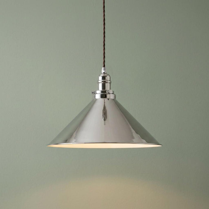Polished nickel industrial cone pendant light with a twisted brown cord against a sage green background.