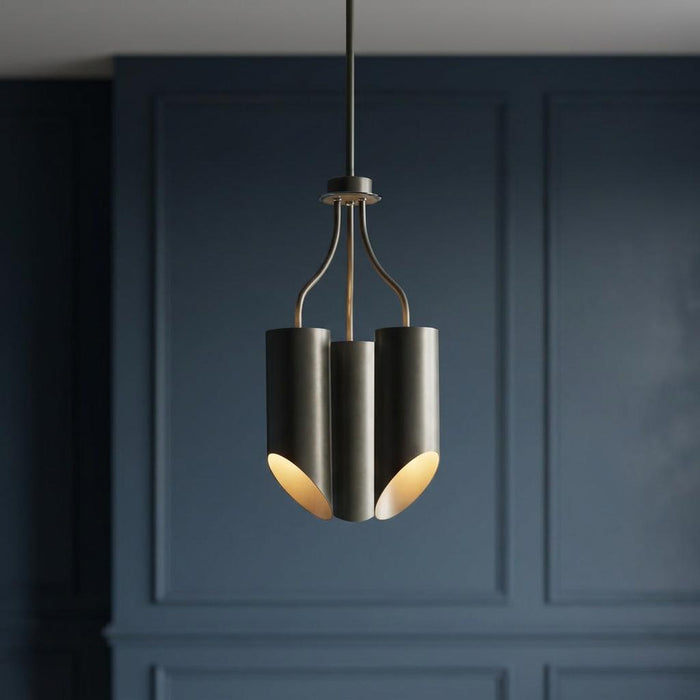 Elstead Quinto grey and polished nickel chandelier with three cylindrical shades against a blue paneled wall.