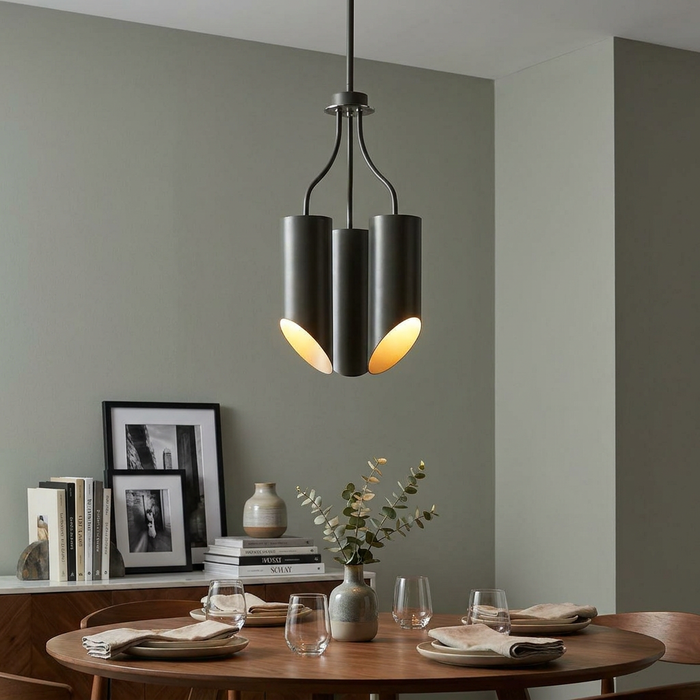 Elstead Quinto 3 light grey chandelier with angled cylindrical shades hanging over a wooden dining table.