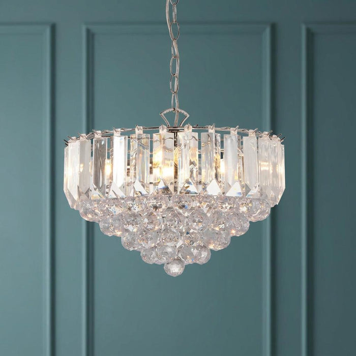 Endon Fargo chrome and clear acrylic 3-light ceiling pendant with glowing crystals against a teal paneled wall.