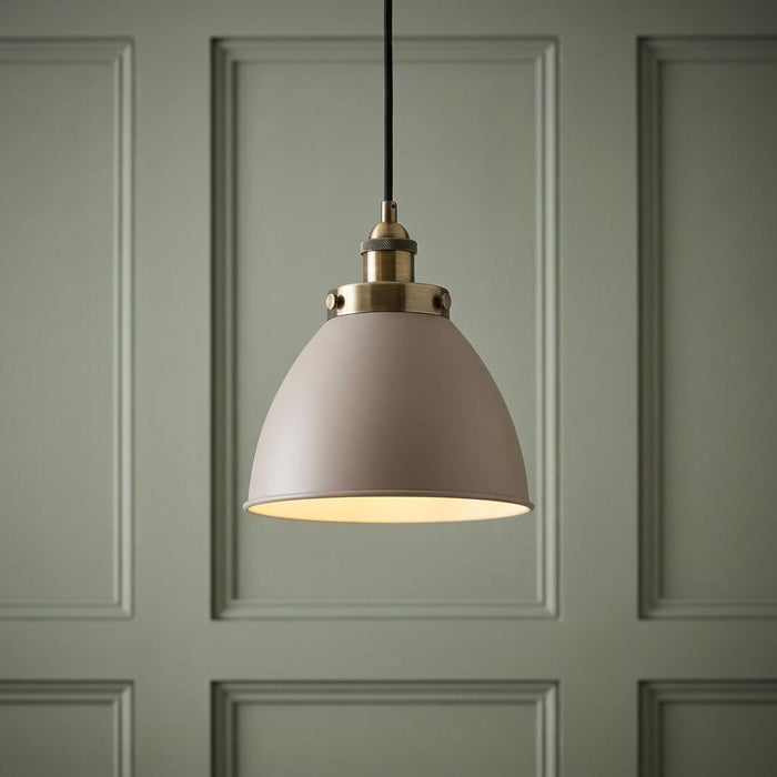 Endon Franklin 1 Light Brass Ceiling Pendant with a taupe dome shade against a green paneled wall.