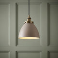 Endon Franklin 1 Light Brass Ceiling Pendant with a taupe dome shade against a green paneled wall.